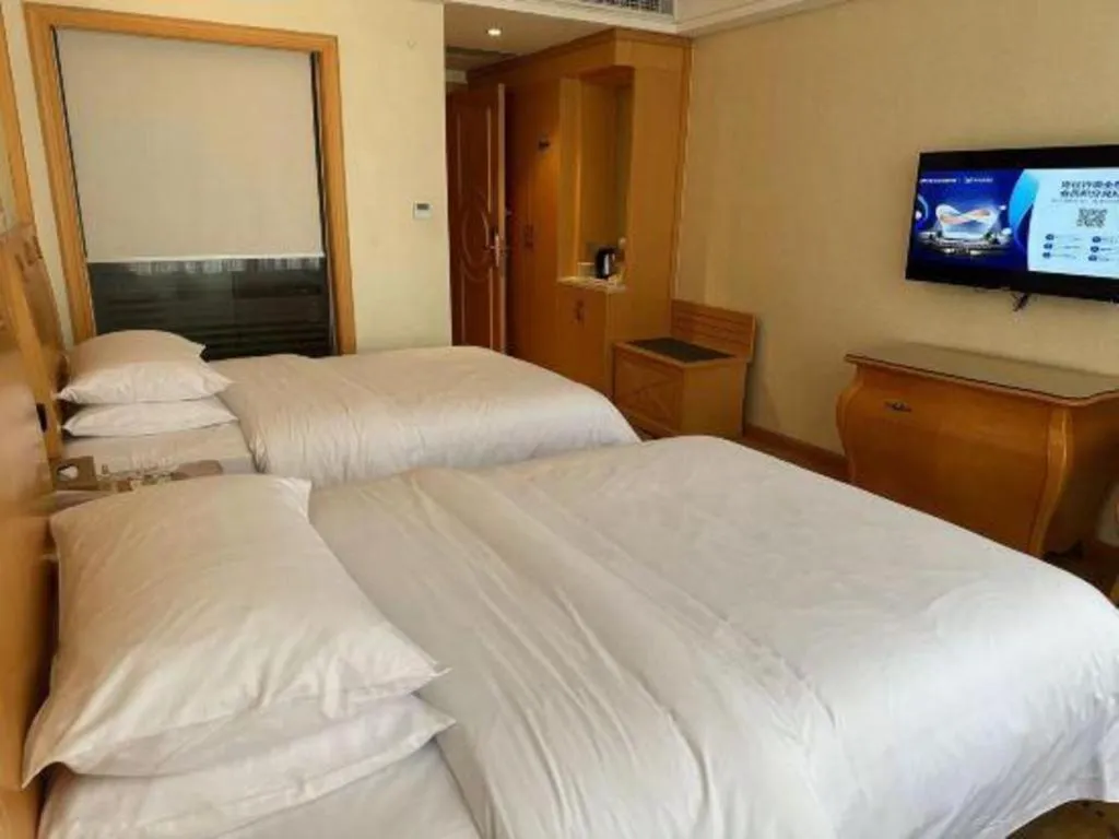 Bed in Vienna Hotel Guangdong Zhaoqing Sihui Tianguangxu