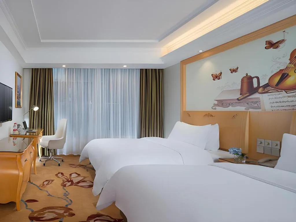 Bed in Vienna Hotel Guangdong Zhaoqing Sihui Tianguangxu