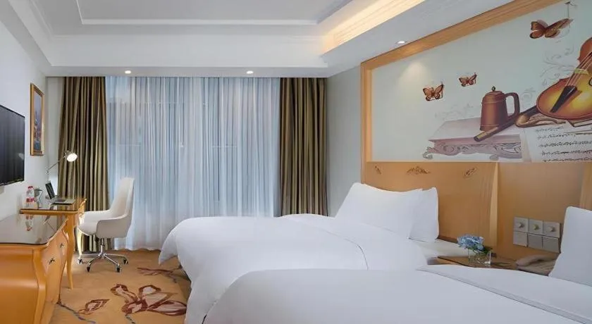Bed in Vienna Hotel Guangdong Zhaoqing Sihui Tianguangxu