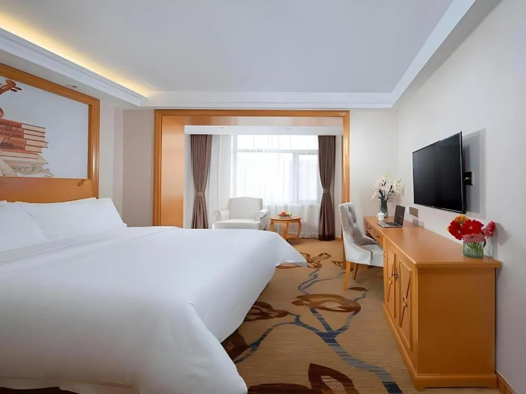 Bed in Vienna Hotel Jilin Dunhua High-Speed Railway Station