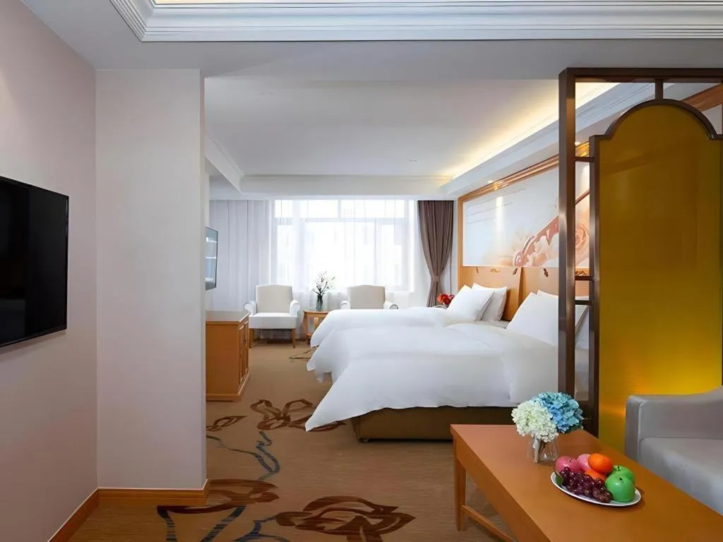 Bed in Vienna Hotel Jilin Dunhua High-Speed Railway Station