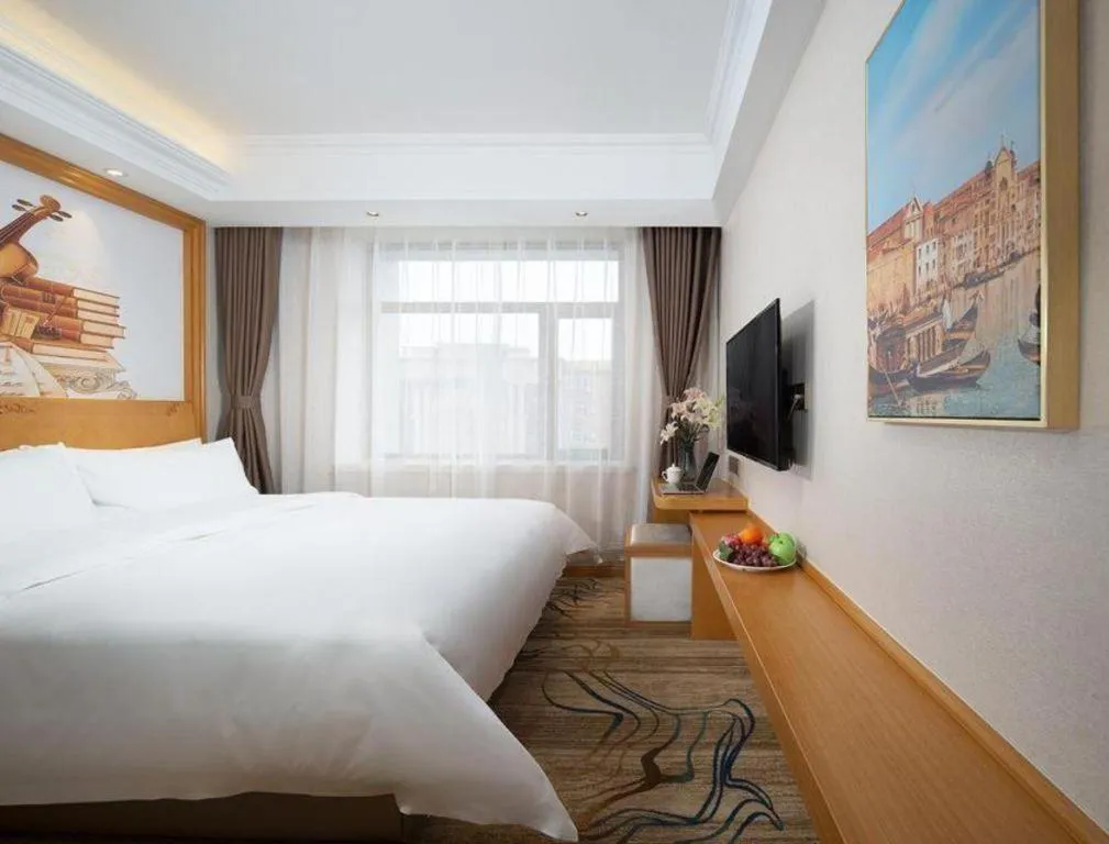 Bed in Vienna Hotel Jilin Dunhua High-Speed Railway Station