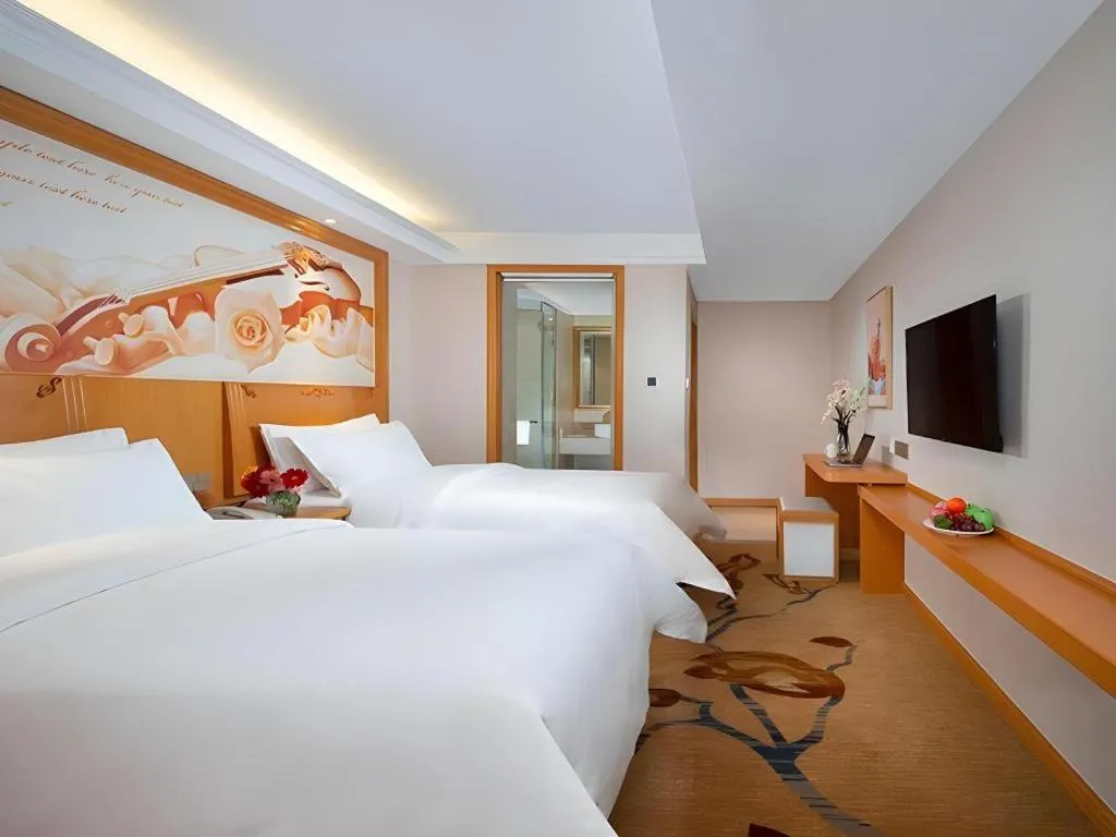 Bed in Vienna Hotel Jilin Dunhua High-Speed Railway Station