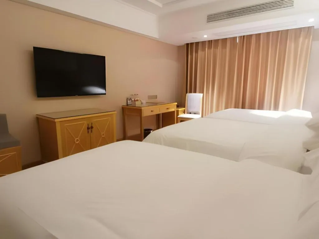 Bed in Vienna Hotel Guangxi Hezhou Guposhan Suifeng