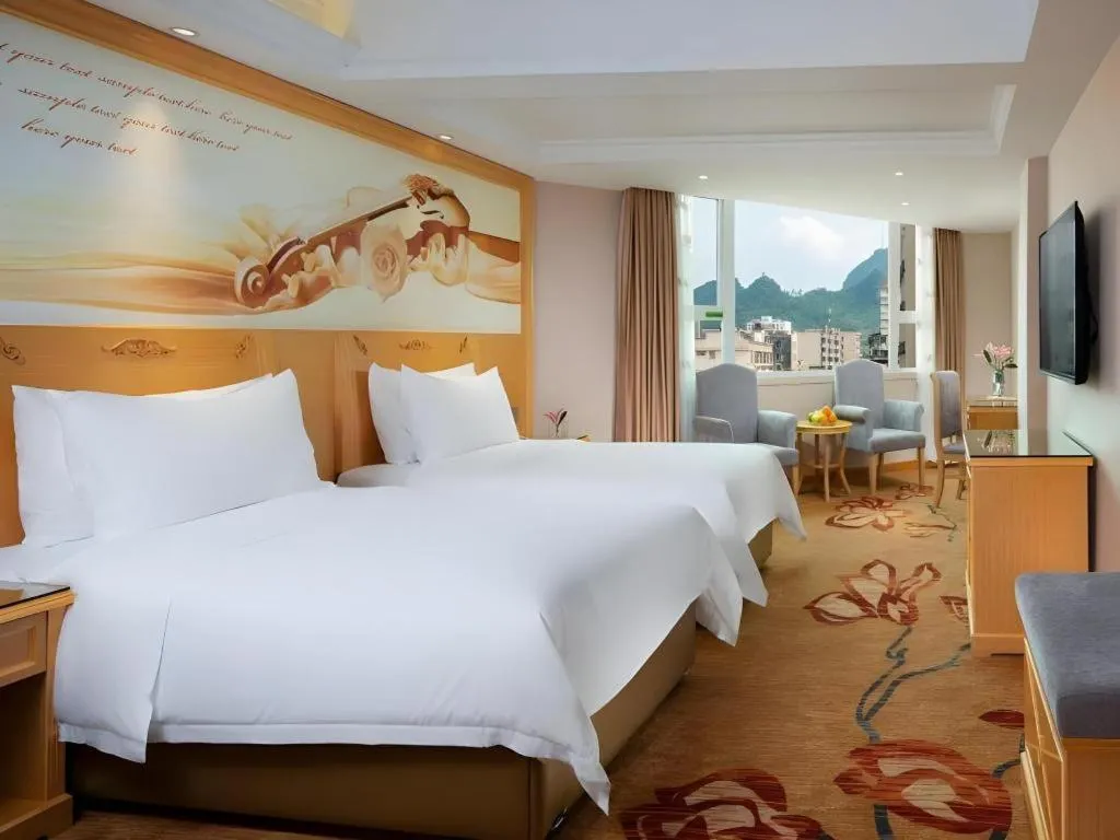 Bed in Vienna Hotel Guangxi Hezhou Guposhan Suifeng