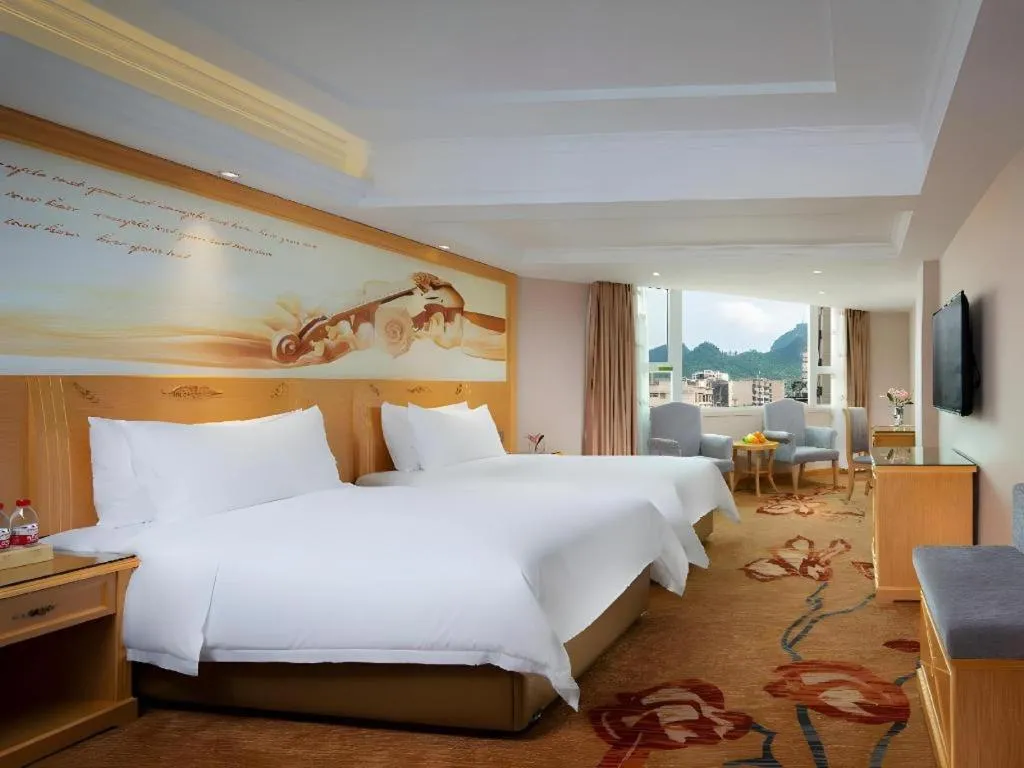 Bed in Vienna Hotel Guangxi Hezhou Guposhan Suifeng