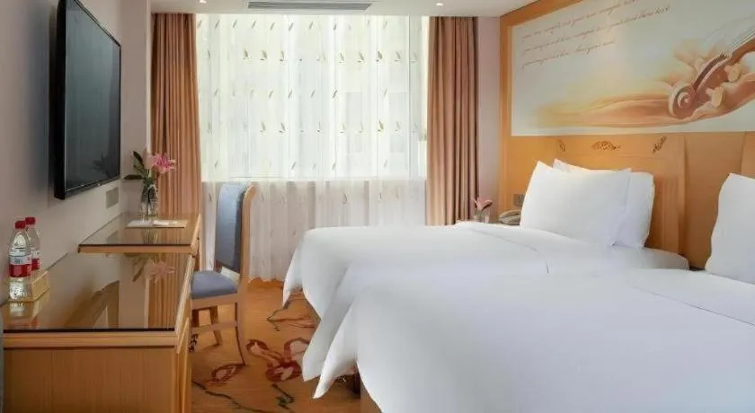 Bed in Vienna Hotel Guangxi Hezhou Guposhan Suifeng