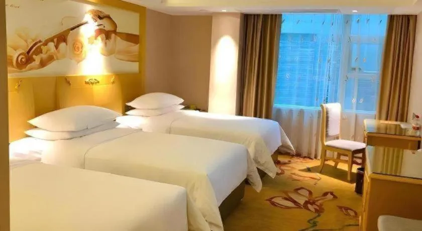 Bed in Vienna Hotel Guangxi Hezhou Guposhan Suifeng