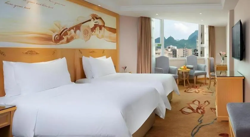 Bed in Vienna Hotel Guangxi Hezhou Guposhan Suifeng