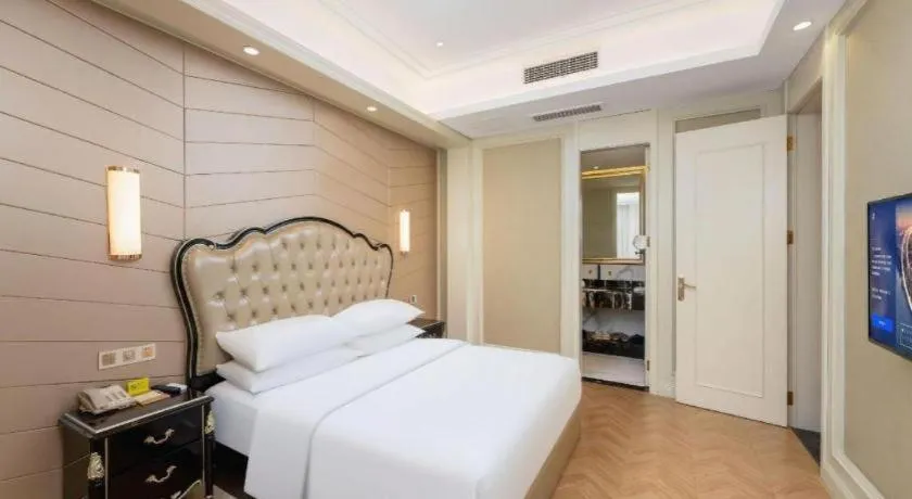 Bed in Vienna Hotel Jiangsu Zhangjiagang Passenger Terminal Station