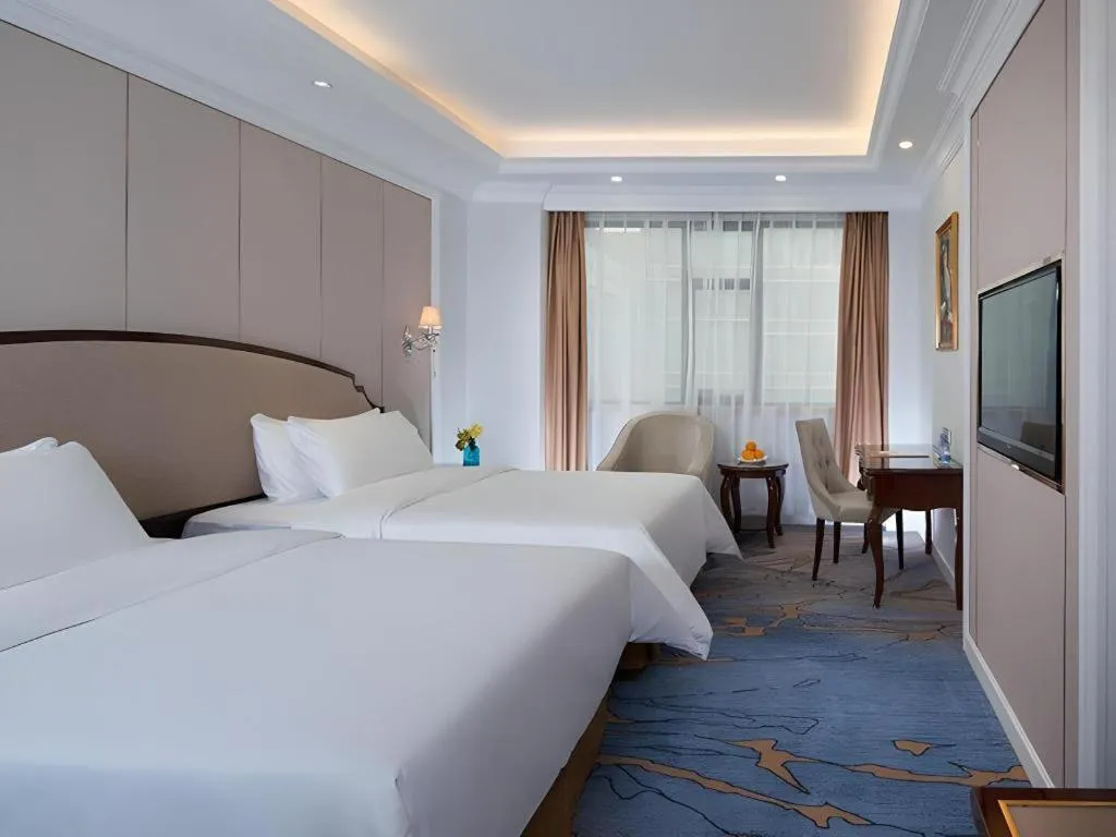 Bed in Vienna Hotel Guangzhou Baiyun College Jinyuan Plaza
