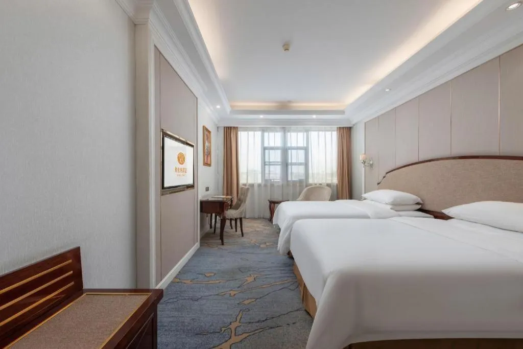 Bed in Vienna Hotel Guangzhou Baiyun College Jinyuan Plaza
