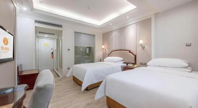 Bed in Vienna Hotel Guangzhou Baiyun College Jinyuan Plaza