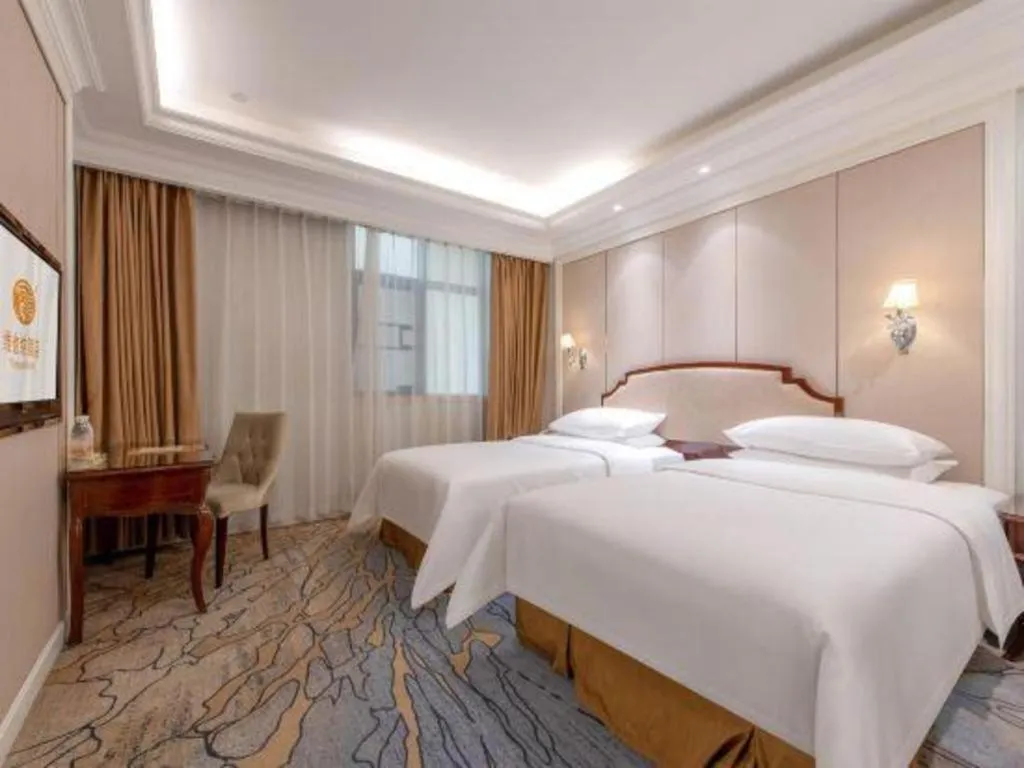 Bed in Vienna Hotel Guangzhou Baiyun College Jinyuan Plaza