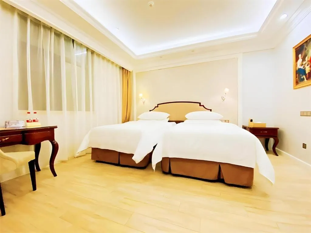 Bed in Vienna Hotel Guangzhou Baiyun College Jinyuan Plaza