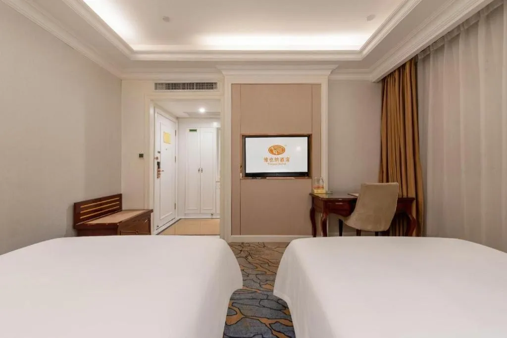 Bed in Vienna Hotel Guangzhou Baiyun College Jinyuan Plaza