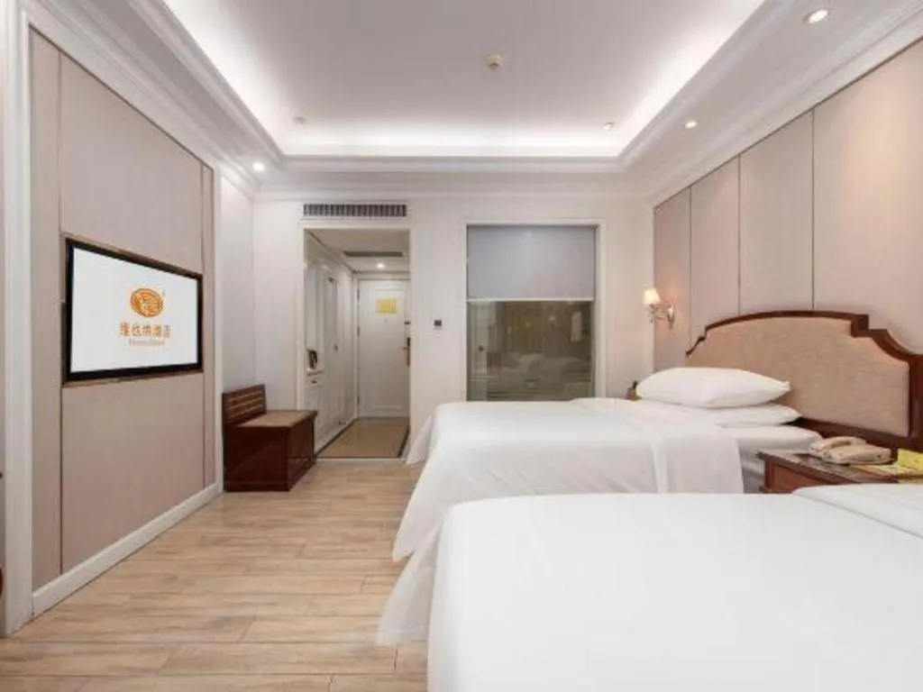 Bed in Vienna Hotel Guangzhou Baiyun College Jinyuan Plaza
