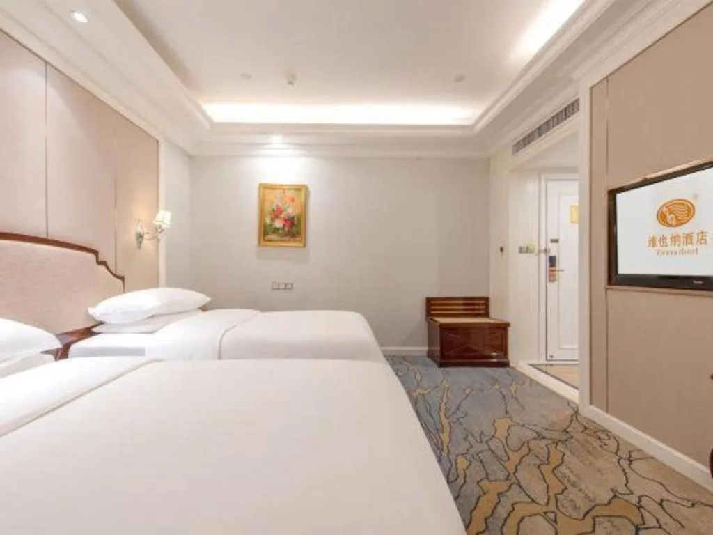 Bed in Vienna Hotel Guangzhou Baiyun College Jinyuan Plaza