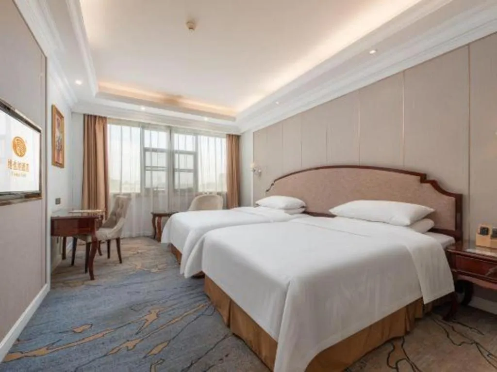 Bed in Vienna Hotel Guangzhou Baiyun College Jinyuan Plaza