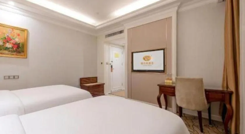 Bed in Vienna Hotel Guangzhou Baiyun College Jinyuan Plaza