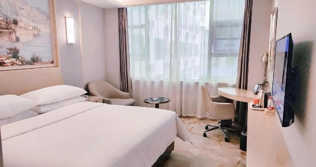 Bed in Vienna Hotel Guangxi Hechi Jinchengjiang Baima Street