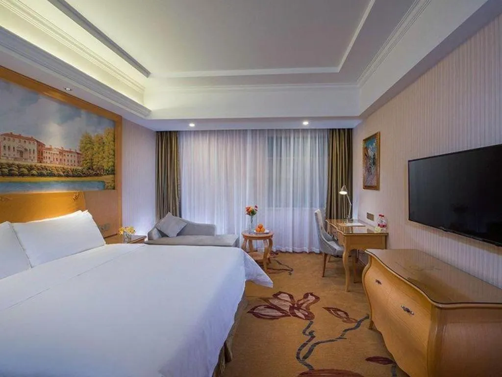 Bed in Vienna Hotel Guangdong Meizhou Fengshun