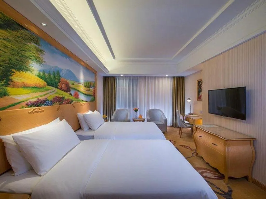 Bed in Vienna Hotel Guangdong Meizhou Fengshun
