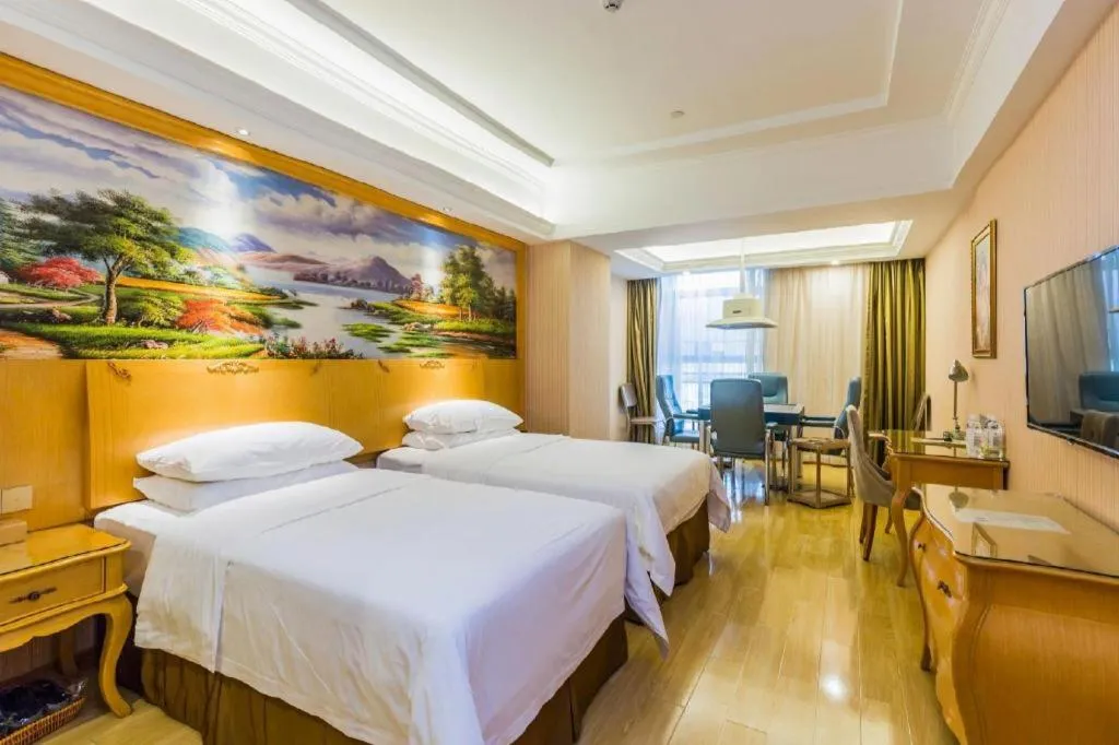 Bed in Vienna Hotel Guangdong Meizhou Fengshun