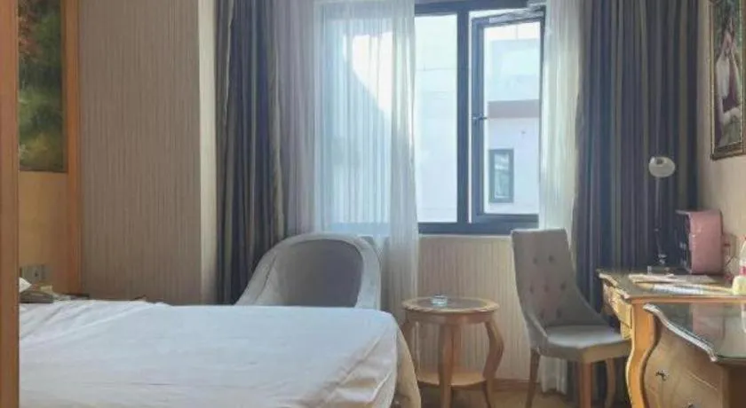 Bed in Vienna Hotel Guangdong Meizhou Fengshun