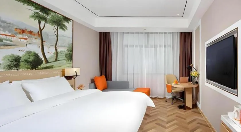 Bed in Vienna Hotel Guangxi Baise Xilin County Juting Cultural Arts Center