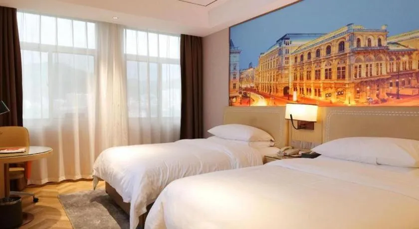 Bed in Vienna Hotel Guangxi Baise Xilin County Juting Cultural Arts Center