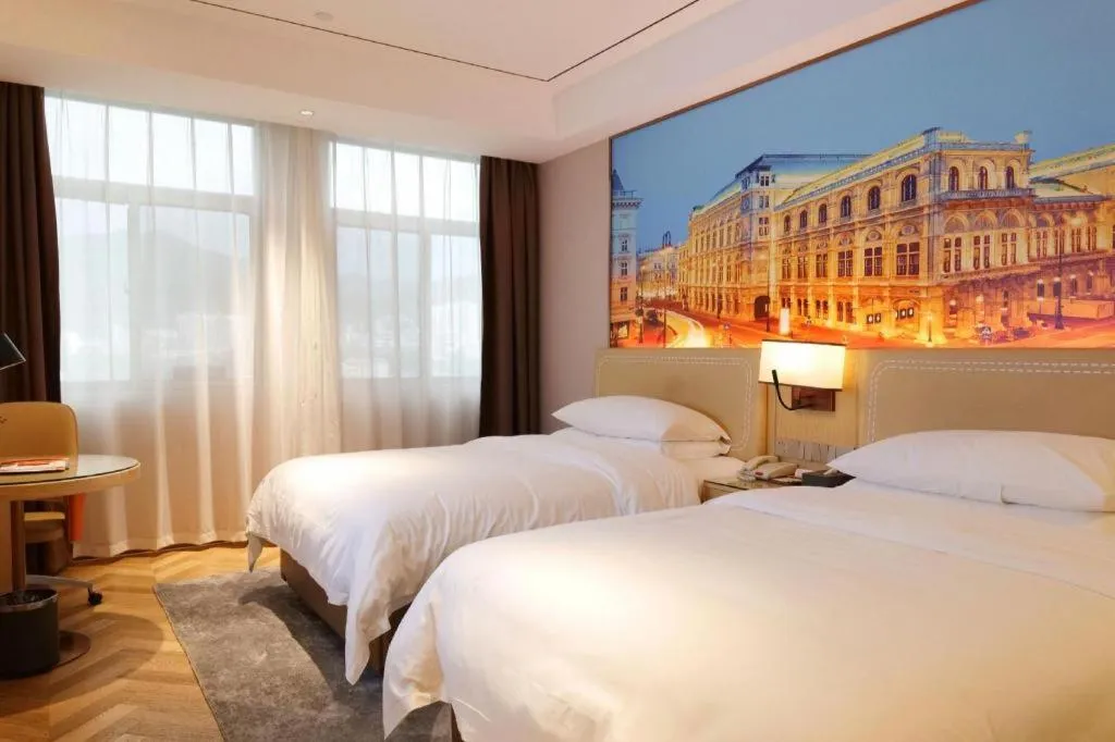 Bed in Vienna Hotel Guangxi Baise Xilin County Juting Cultural Arts Center