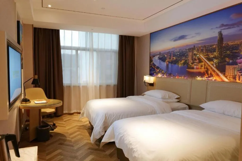 Bed in Vienna Hotel Guangxi Baise Xilin County Juting Cultural Arts Center