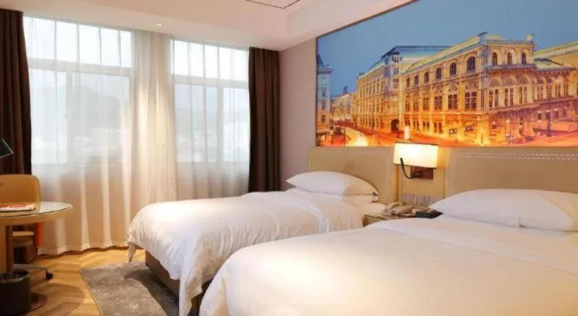 Bed in Vienna Hotel Guangxi Baise Xilin County Juting Cultural Arts Center