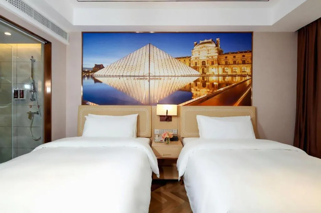 Bed in Vienna Hotel Guangxi Baise Xilin County Juting Cultural Arts Center