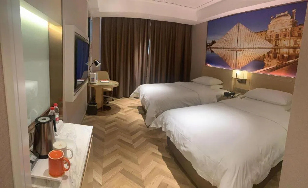 Bed in Vienna Hotel Guangxi Baise Xilin County Juting Cultural Arts Center