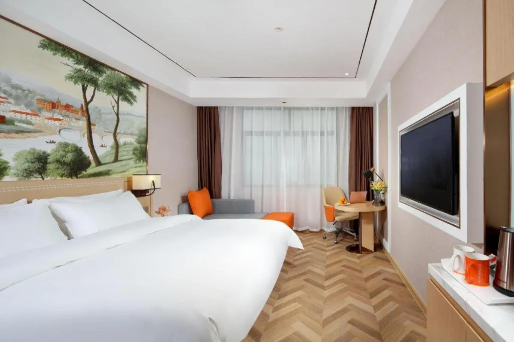 Bed in Vienna Hotel Guangxi Baise Xilin County Juting Cultural Arts Center
