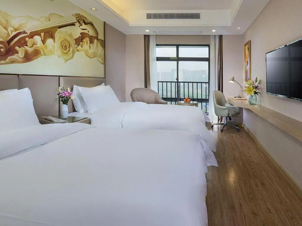 Bed in Vienna Hotel Guangxi Wuzhou High-Tech