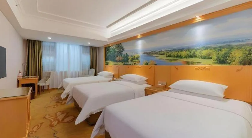 Bed in Vienna Hotel Guangdong Shaoguan Ruyuan Yao Cultural Square