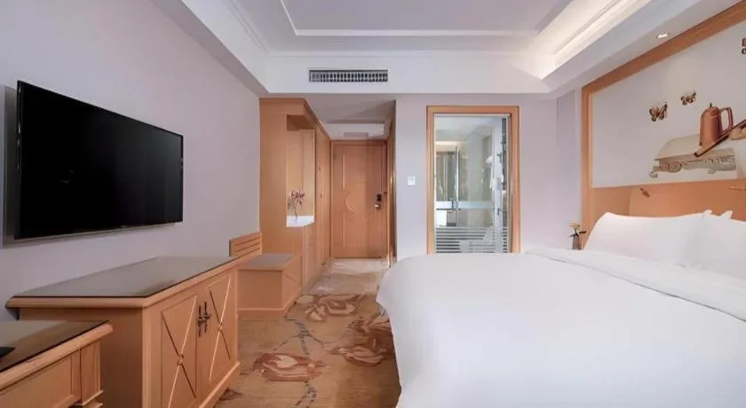 Bed in Vienna Hotel Guangdong Shaoguan Ruyuan Yao Cultural Square