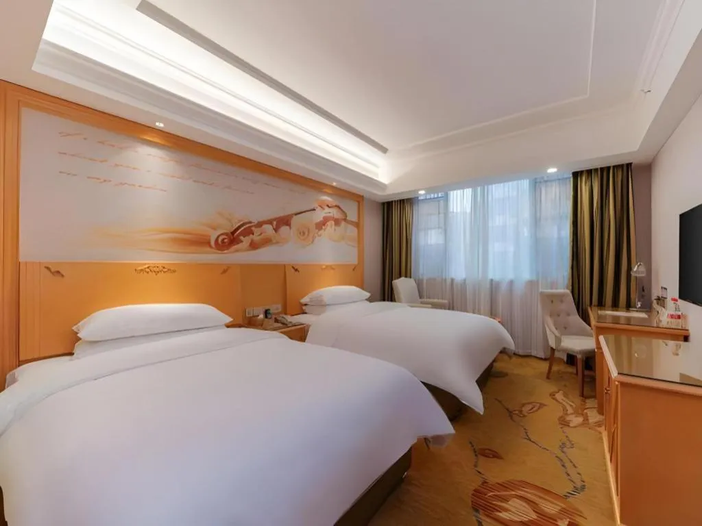 Bed in Vienna Hotel Guangdong Shaoguan Ruyuan Yao Cultural Square