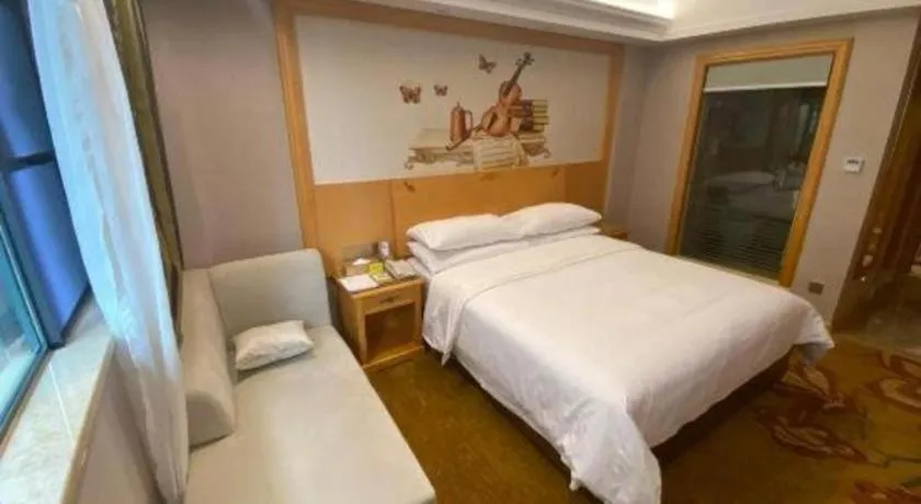 Bed in Vienna Hotel Guangdong Shaoguan Ruyuan Yao Cultural Square