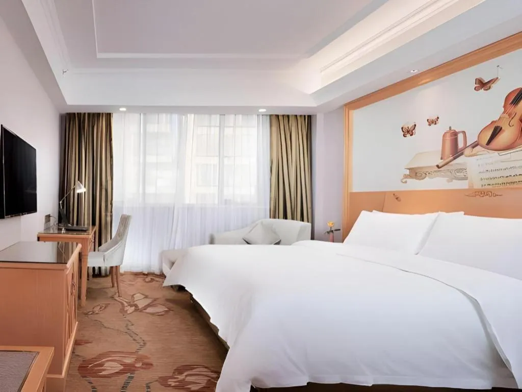 Bed in Vienna Hotel Guangdong Shaoguan Ruyuan Yao Cultural Square