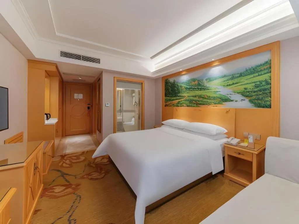 Bed in Vienna Hotel Guangdong Shaoguan Ruyuan Yao Cultural Square