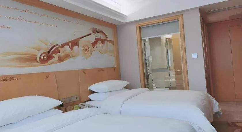 Bed in Vienna Hotel Guangdong Shaoguan Ruyuan Yao Cultural Square