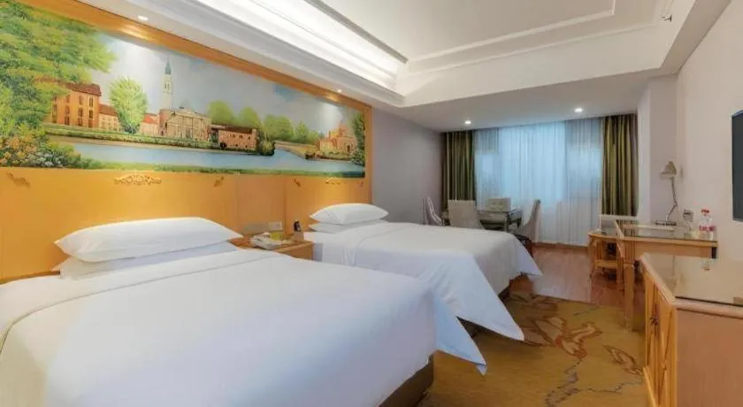 Bed in Vienna Hotel Guangdong Shaoguan Ruyuan Yao Cultural Square