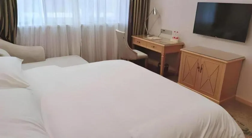 Bed in Vienna Hotel Guangdong Shaoguan Ruyuan Yao Cultural Square