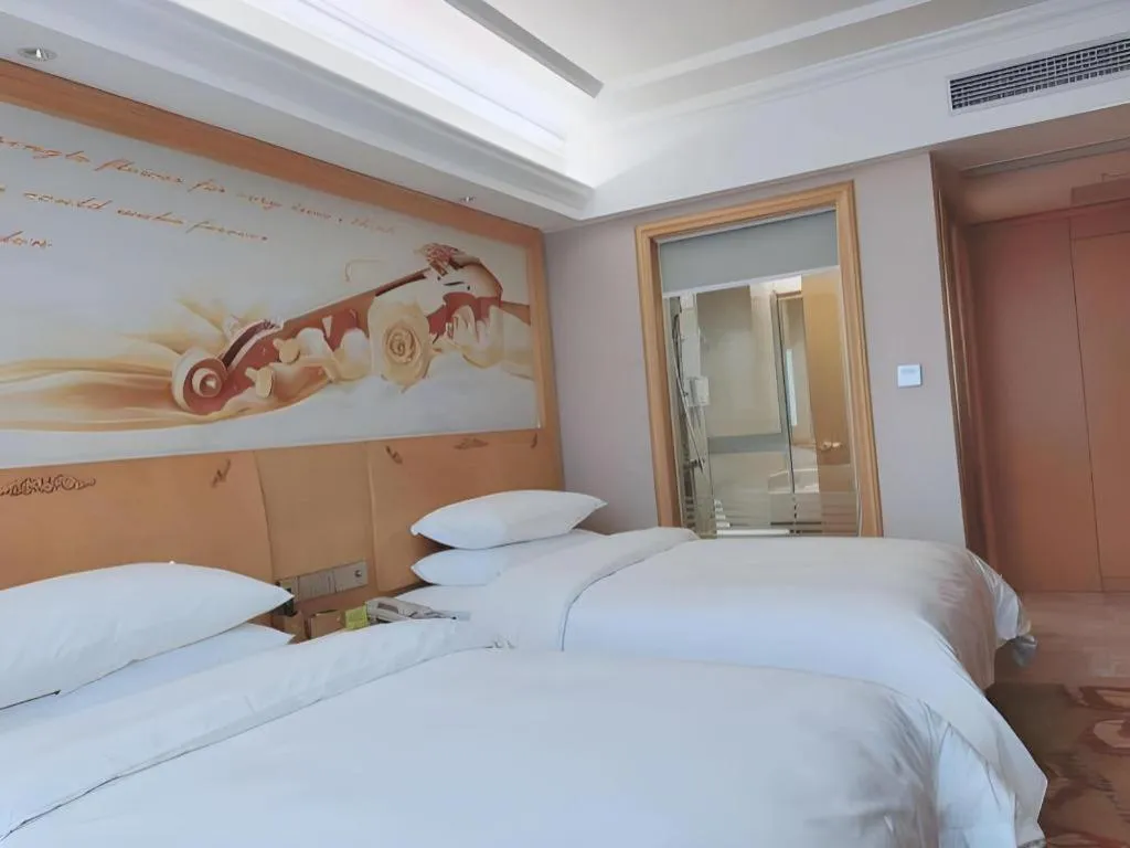 Bed in Vienna Hotel Guangdong Shaoguan Ruyuan Yao Cultural Square