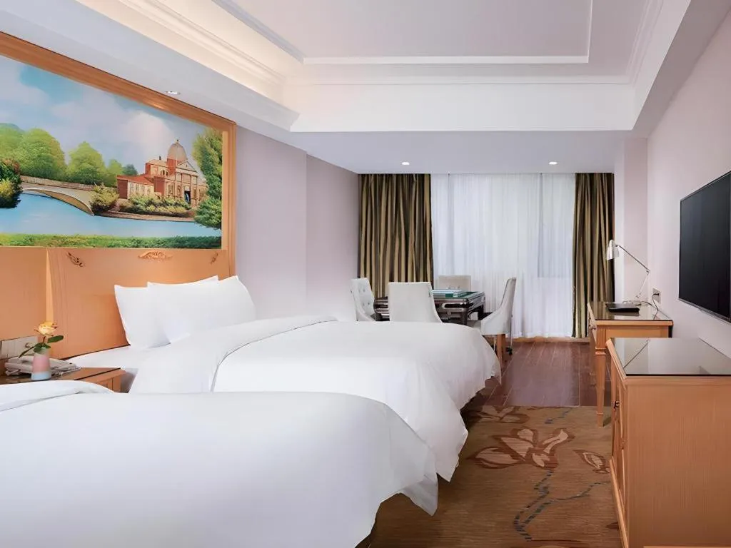 Bed in Vienna Hotel Guangdong Shaoguan Ruyuan Yao Cultural Square