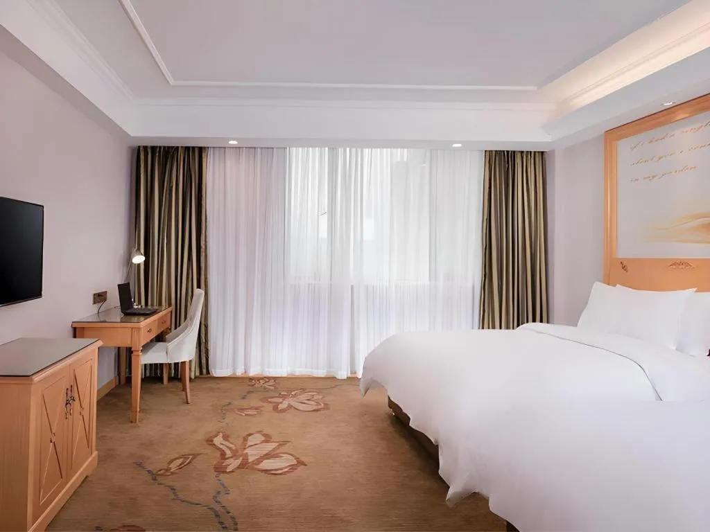 Bed in Vienna Hotel Guangdong Shaoguan Ruyuan Yao Cultural Square